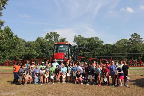 teachers in front of tractor