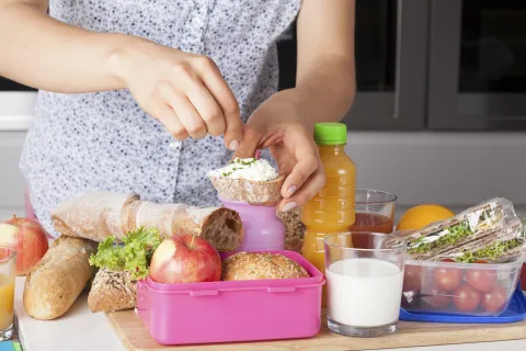 Hands adding garnish to bread